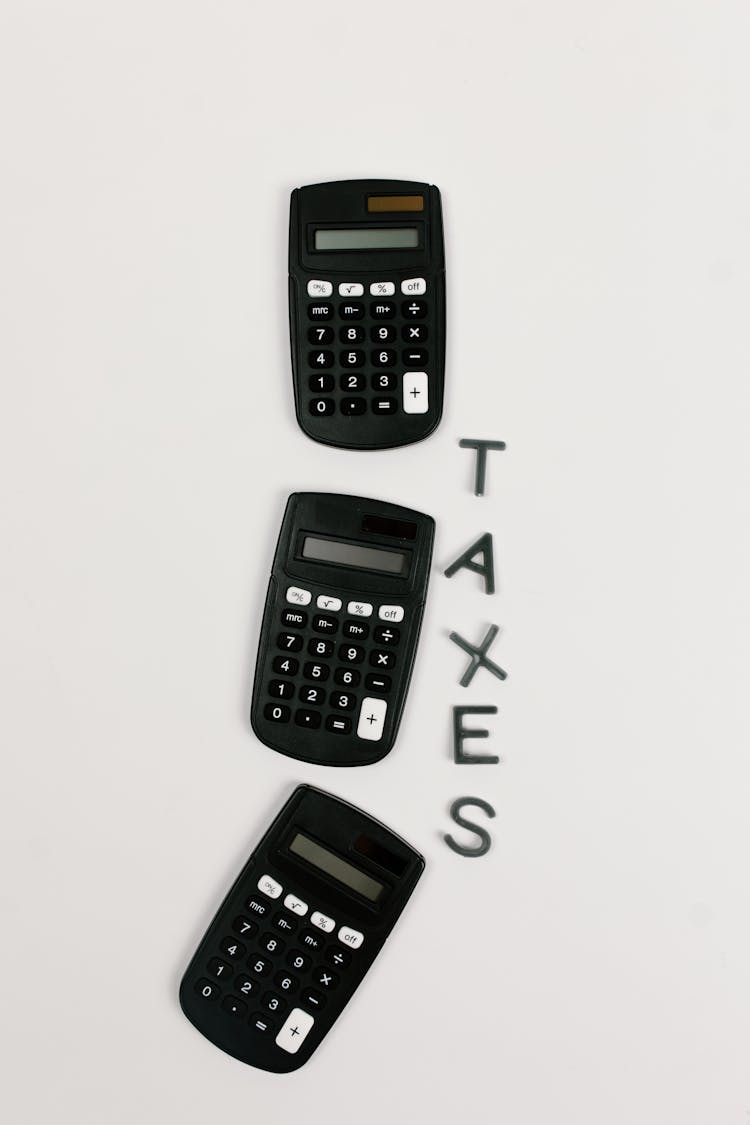 Close-Up Shot Of Black Calculators On A White Surface