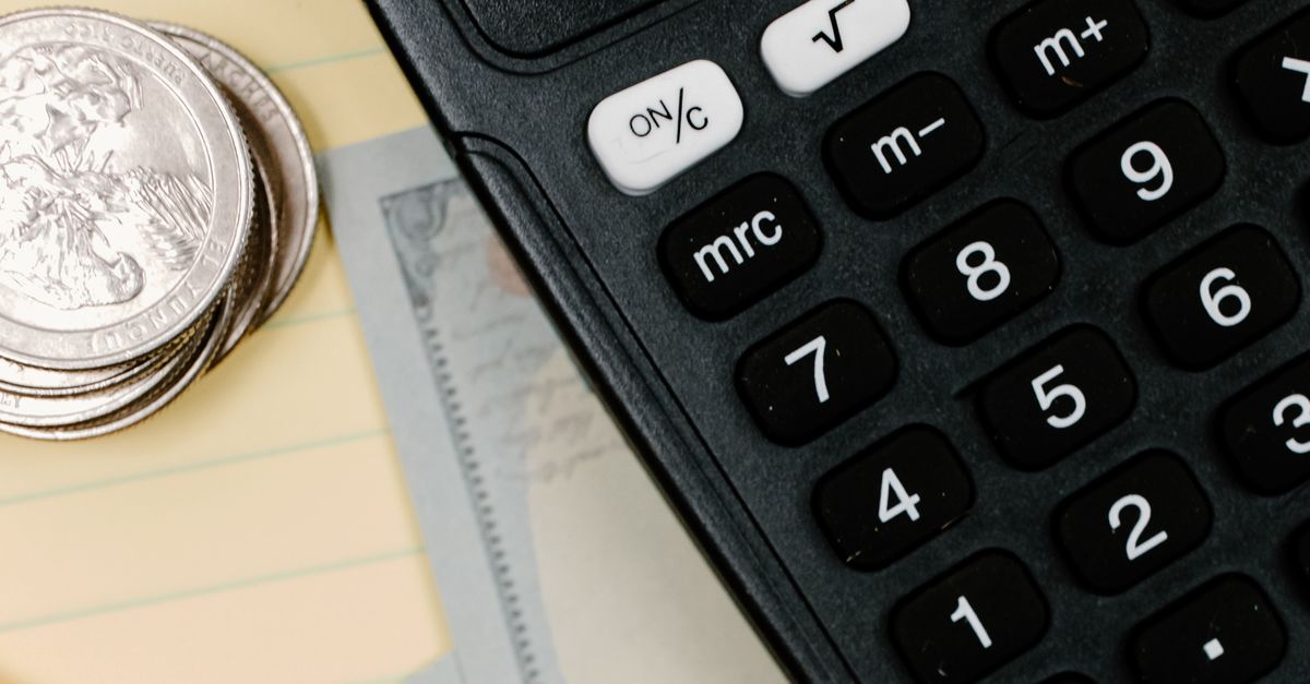 Calculator, cash and notes for emergency budget planning