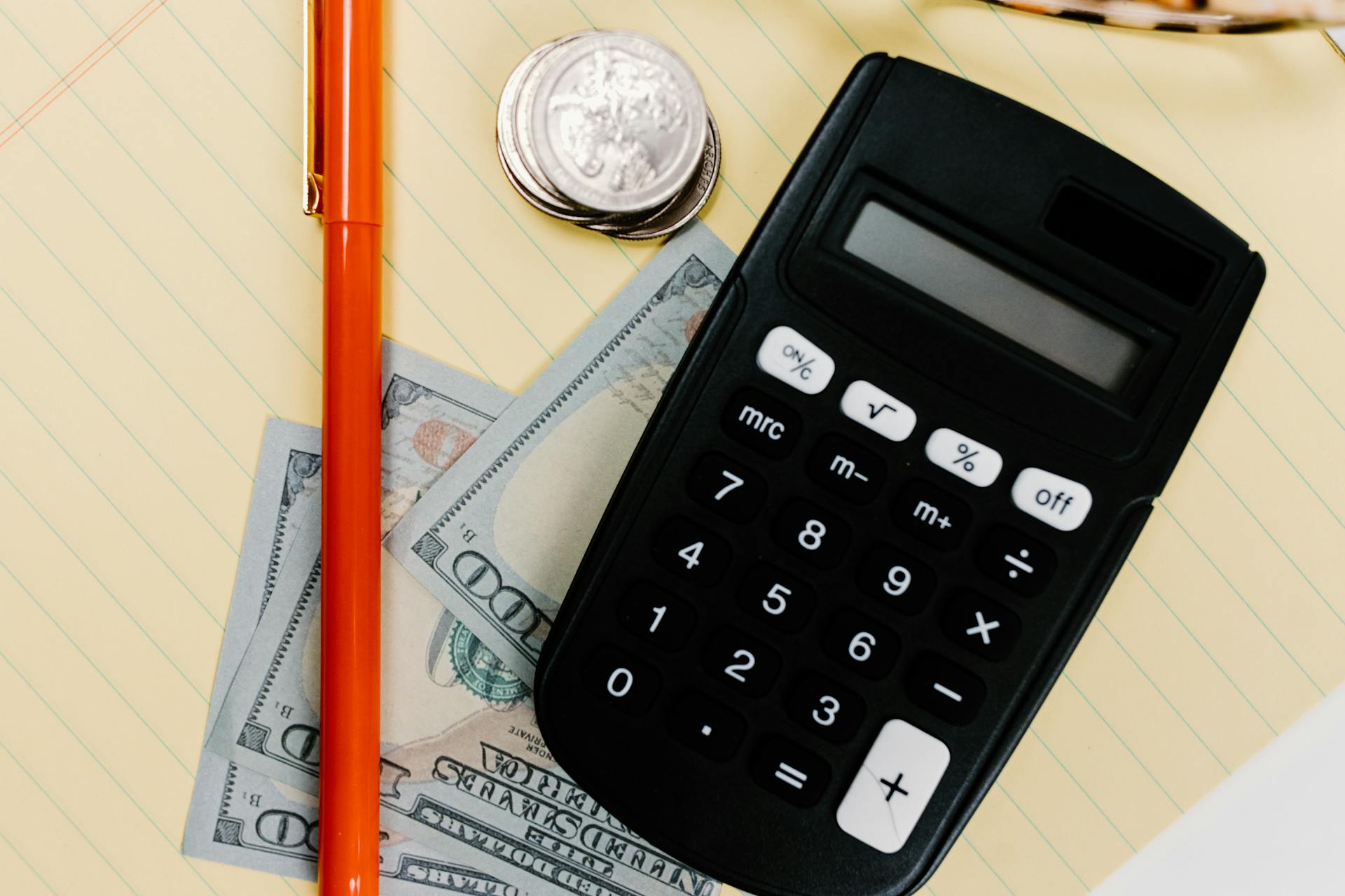 Close-Up Shot of a Calculator on a Yellow Paper