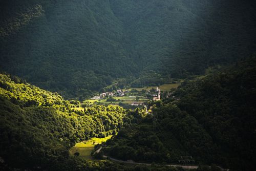 Free A picturesque view of Tenno village nestled in lush, green Trentino mountains, Italy. Stock Photo