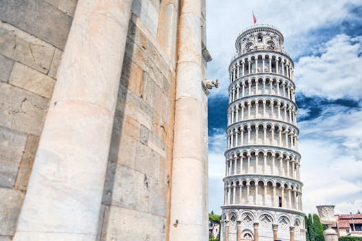 Capture of the famous Leaning Tower of Pisa with clear blue skies, showcasing classic Italian architecture.