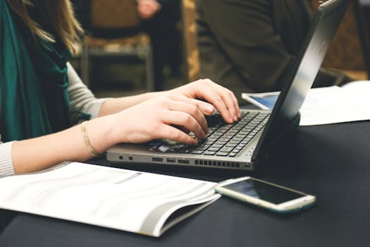 Free stock photo of woman, smartphone, desk, laptop