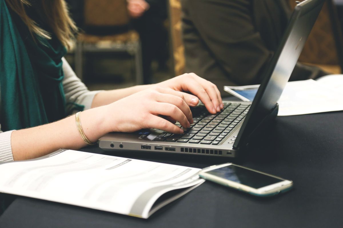 Woman typing on a laptop representing how to build an email list for GLP-1 offers without needing a full website