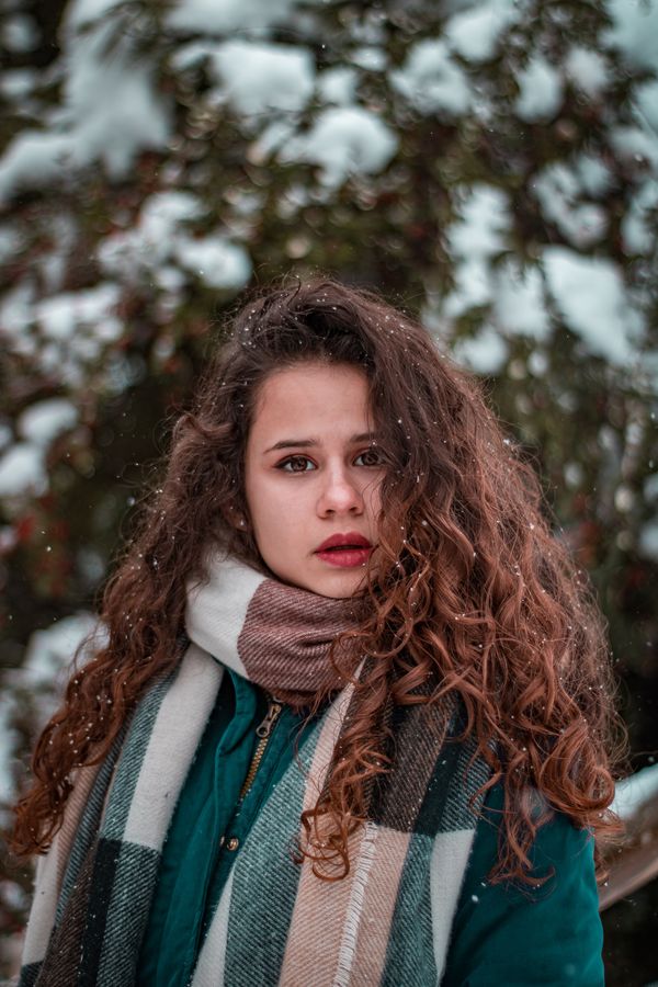 Woman in plaid scarf and winter coat