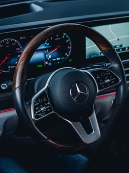 Close-up of a Mercedes steering wheel showcasing luxury car interior design.