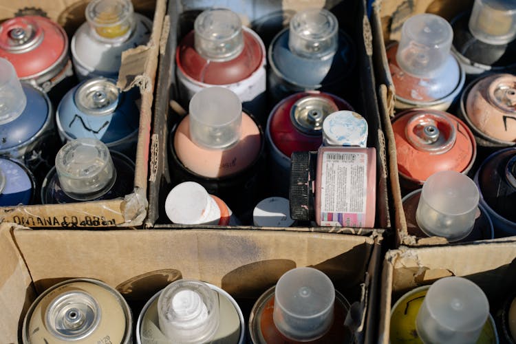 Close-Up Shot Of A Spray Paints In A Box