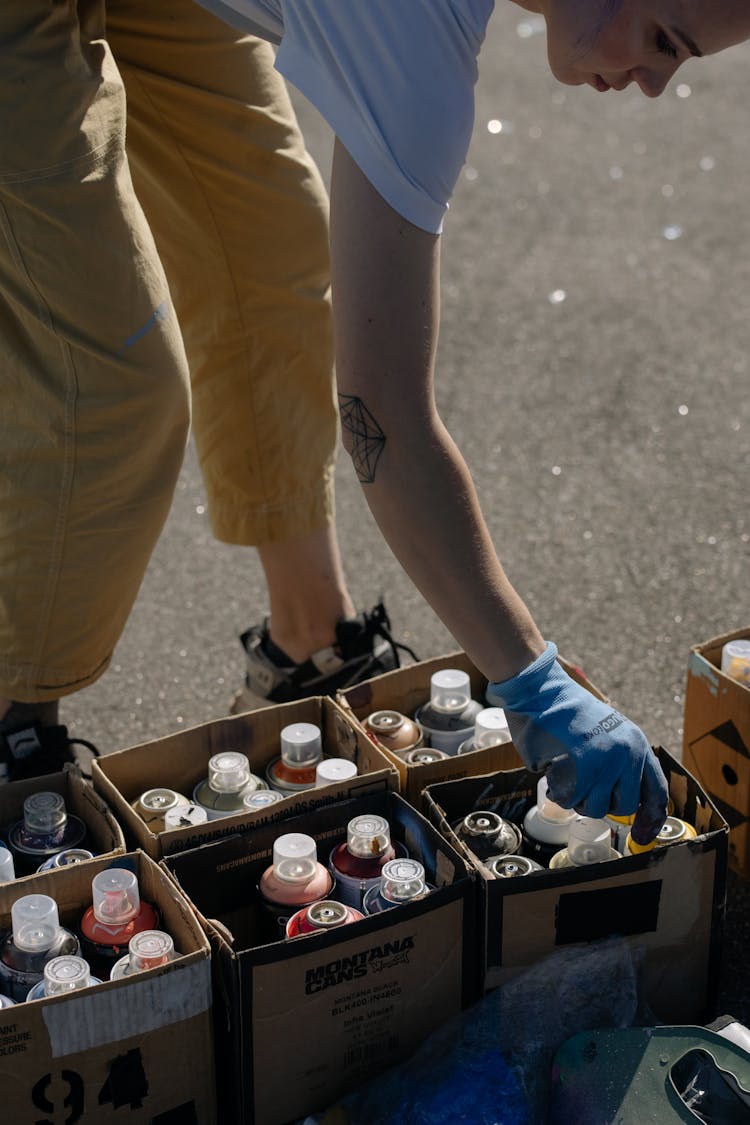 A Woman Picking A Spray Paint