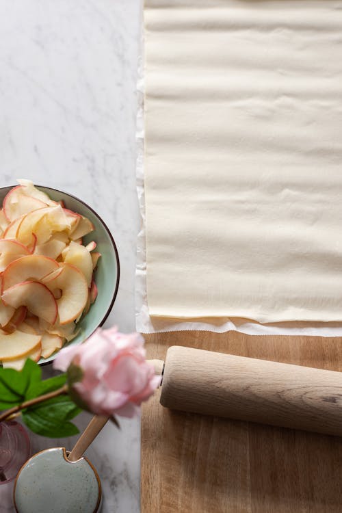 Brown Wooden Rolling Pin on White and Green Floral Ceramic Plate