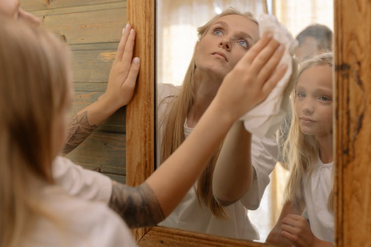 Reflection Of Woman And A Girl On The Mirror