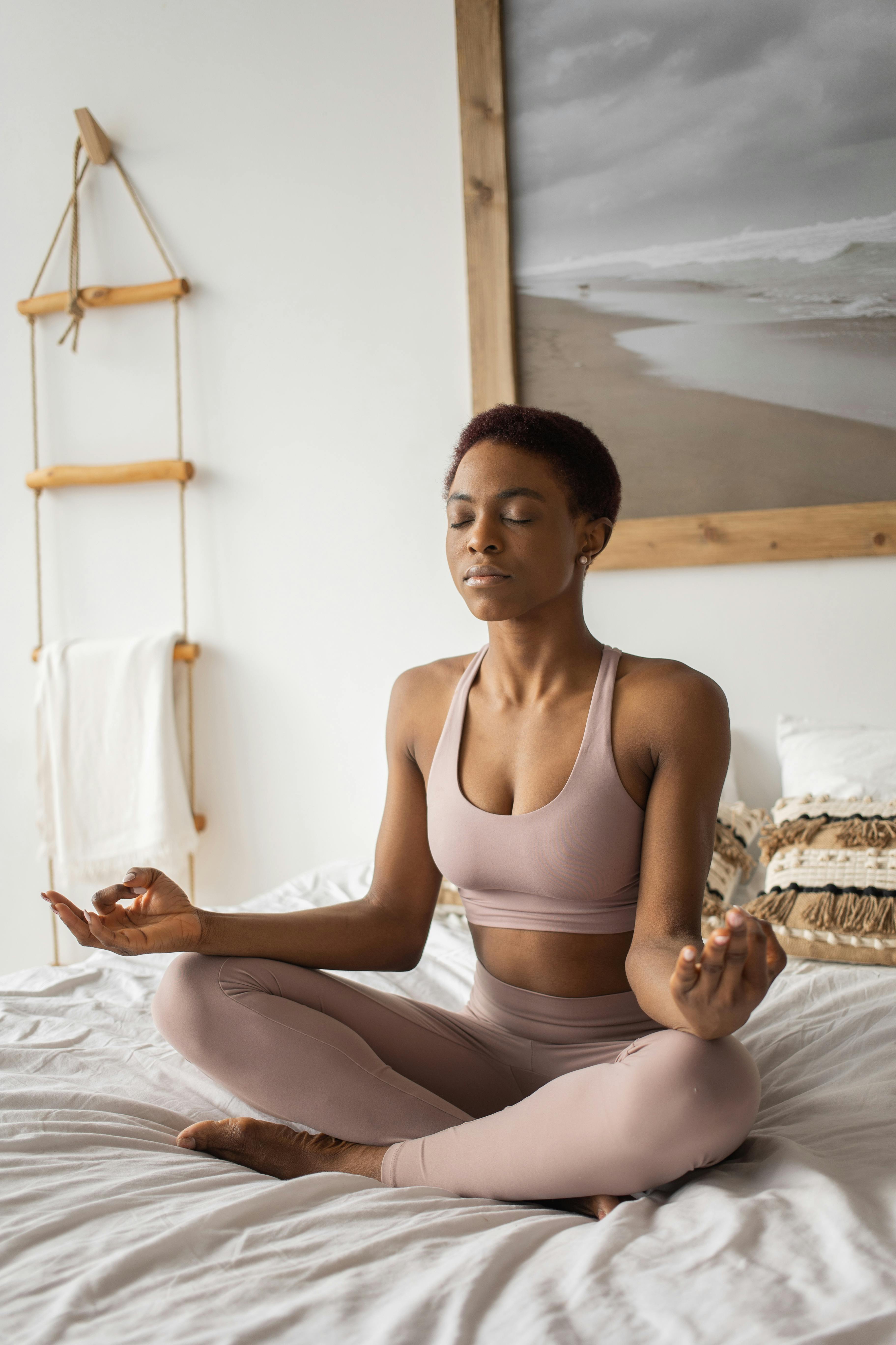 A Woman Doing a Yoga Exercise on the Bed · Free Stock Photo