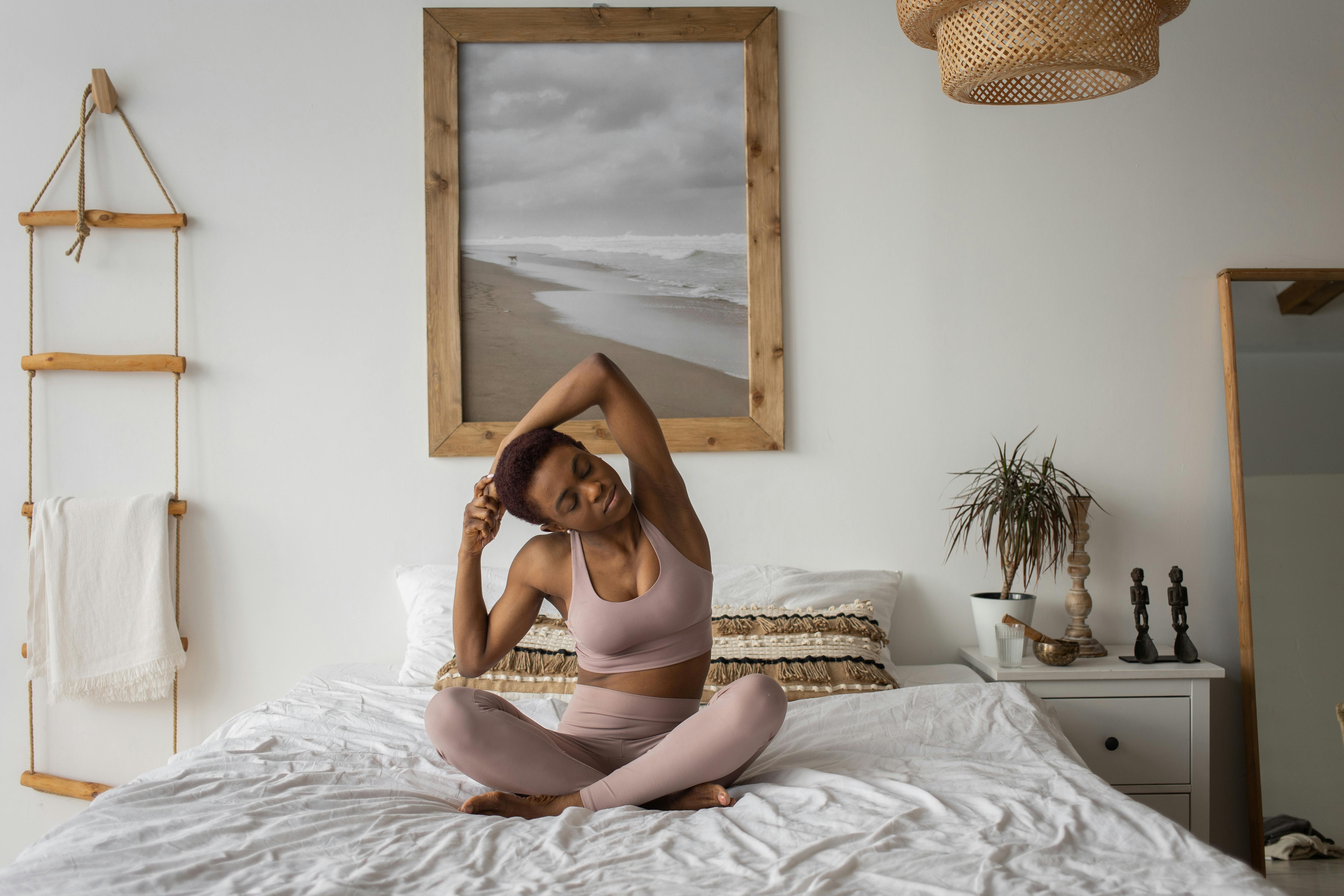 A Woman Doing a Yoga Ritual on a Yoga Mat · Free Stock Photo