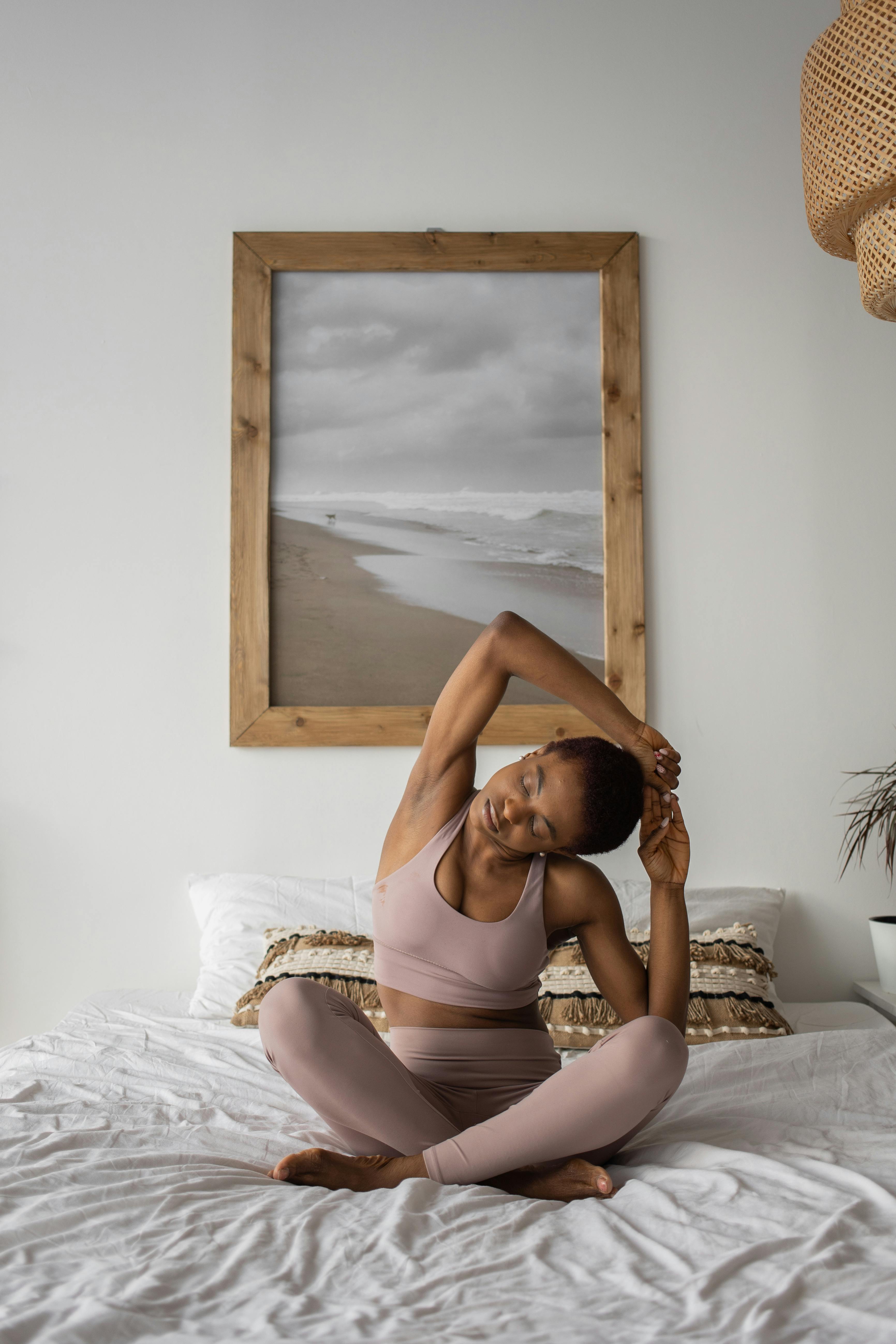 A Woman Doing a Yoga Ritual on a Yoga Mat · Free Stock Photo
