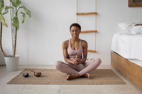 A Woman Doing a Yoga Ritual on a Yoga Mat