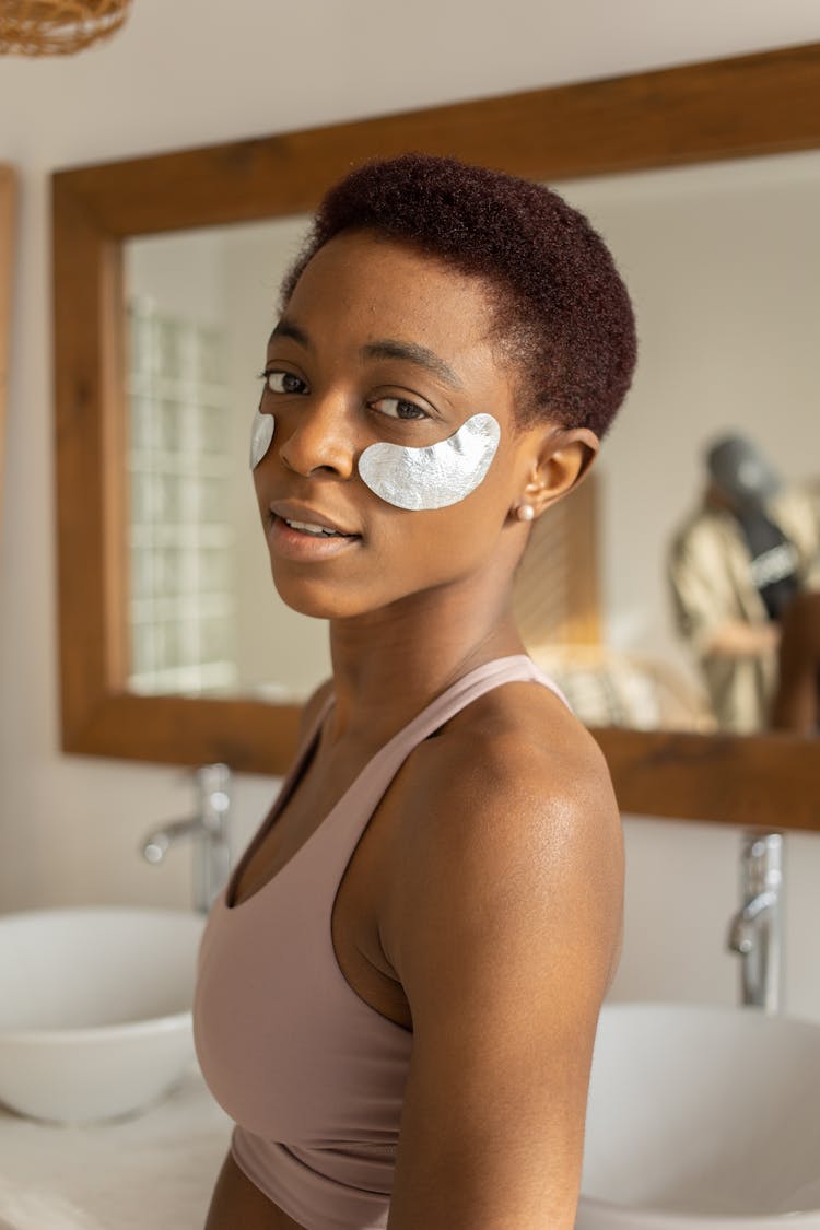 Girl With Cosmetic Pads On Cheeks