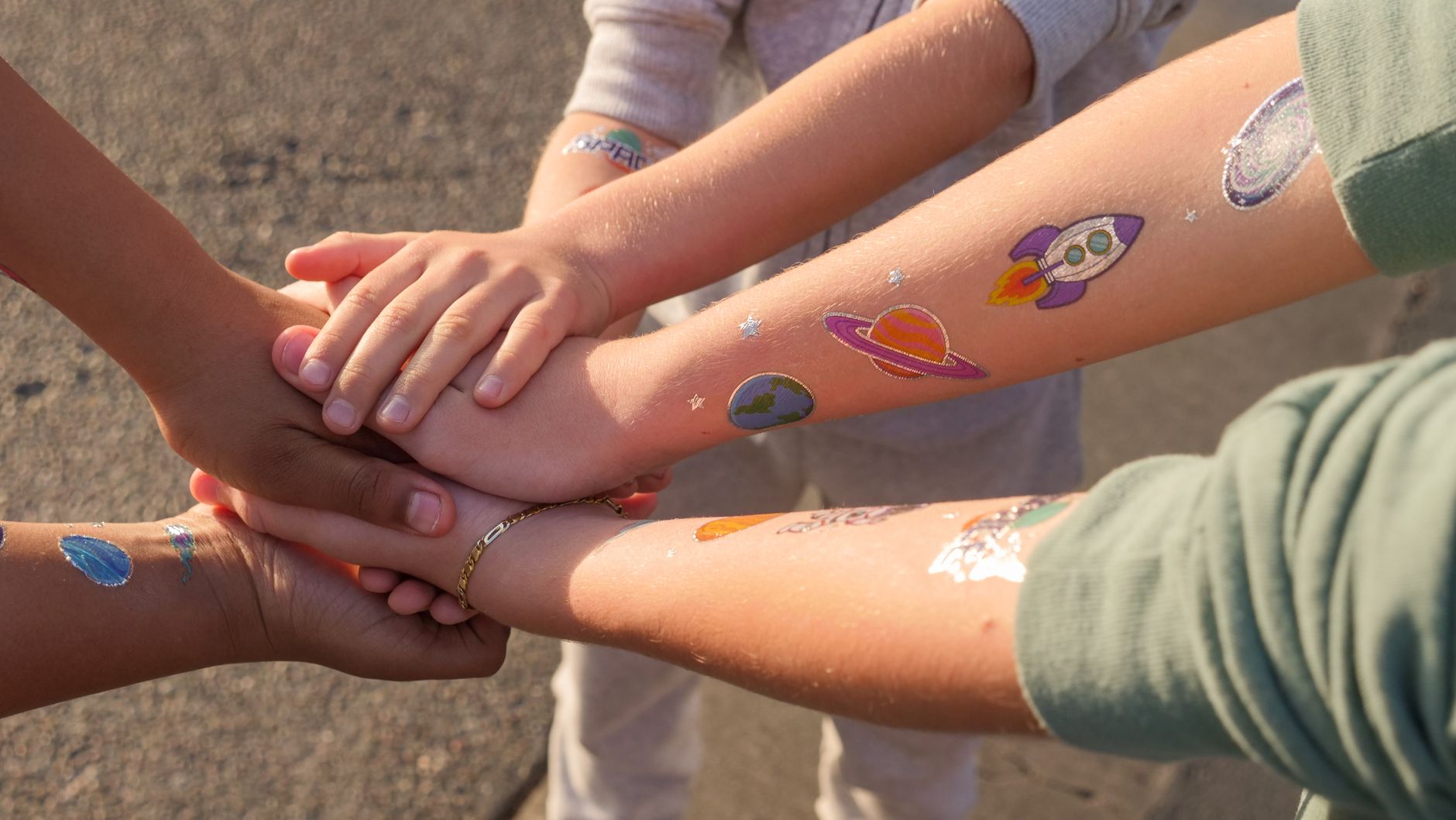 Enfants montrant leurs tatouages temporaires colorés et sans danger sur les avant-bras