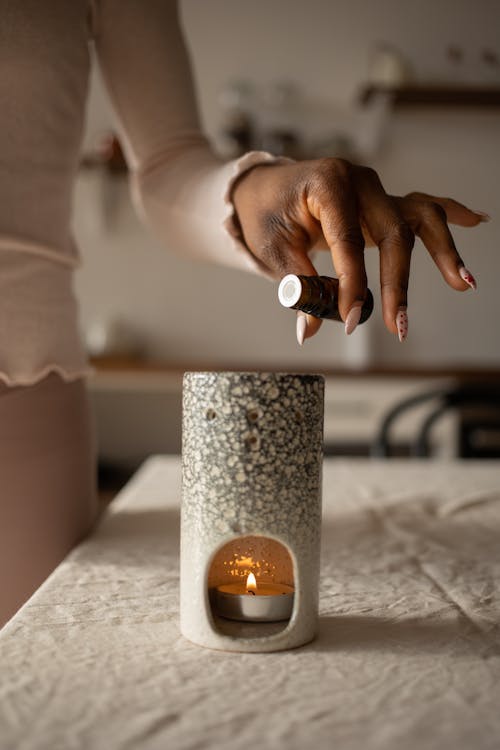 Hand Pouring Scent Oil on Candle