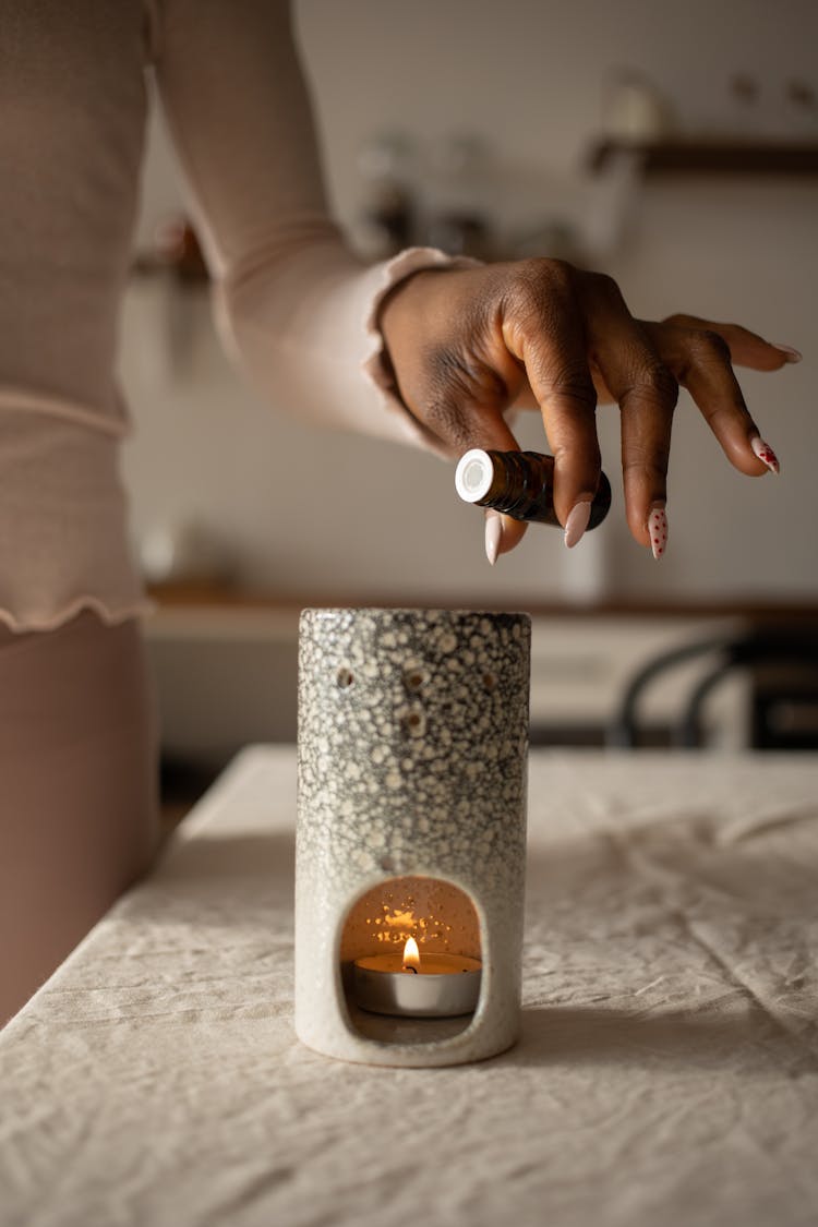 Hand Pouring Scent Oil On Candle