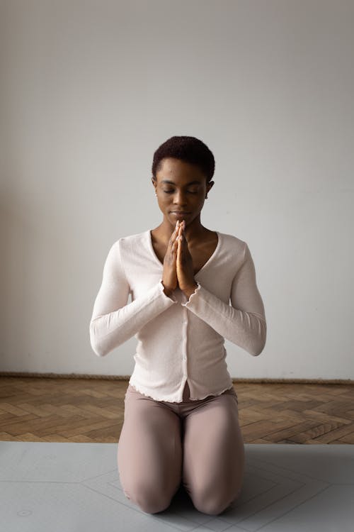 Free Woman Meditating on Floor Stock Photo