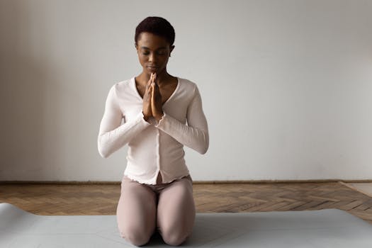 A woman meditating on a yoga mat in a serene indoor setting, emphasizing mindfulness.