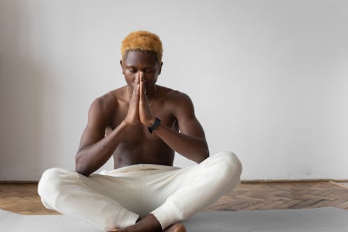 A Man in White Pants Meditating