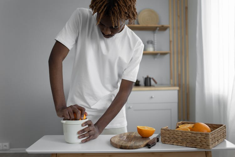 Man Squeezing An Orange