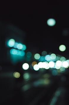 Artistic bokeh effect of city lights glowing against the night sky.