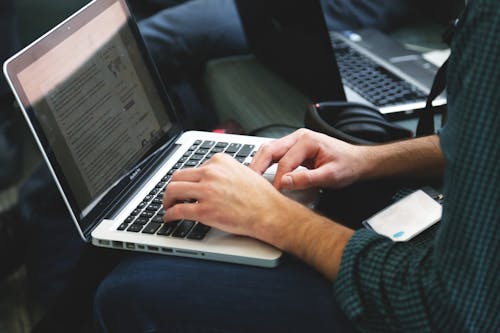 Person's Hands on Macbook Pro