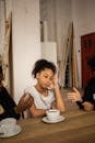 Unhappy black girl near faceless arguing parents