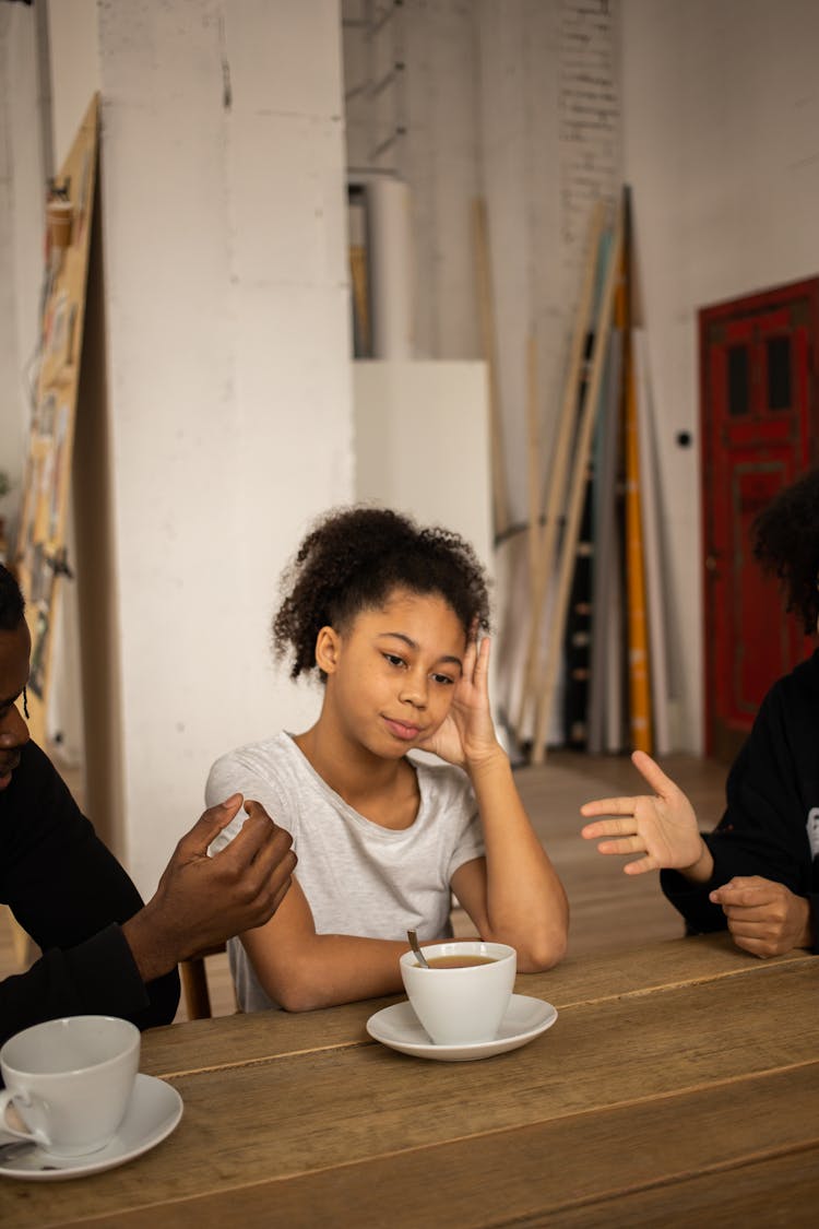 Unhappy Black Girl Near Faceless Arguing Parents