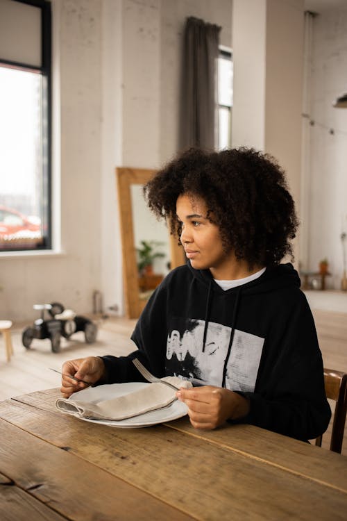 Black woman with plate at table