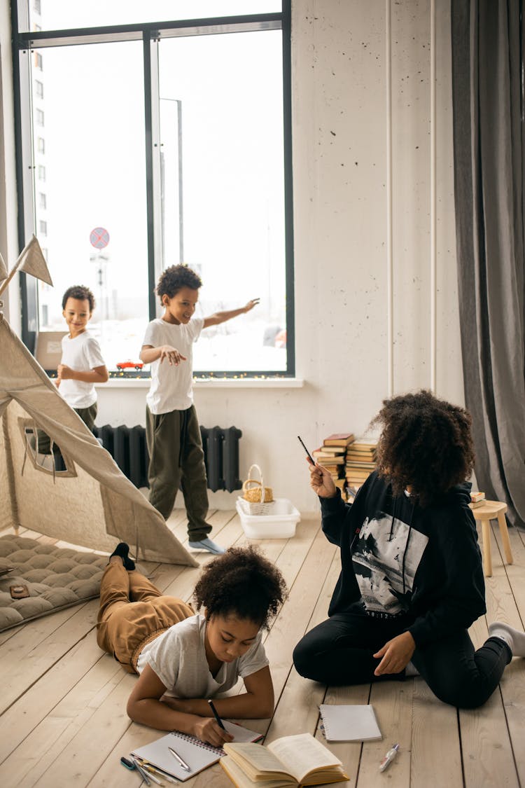 Black Mother Spending Time With Kids In Room