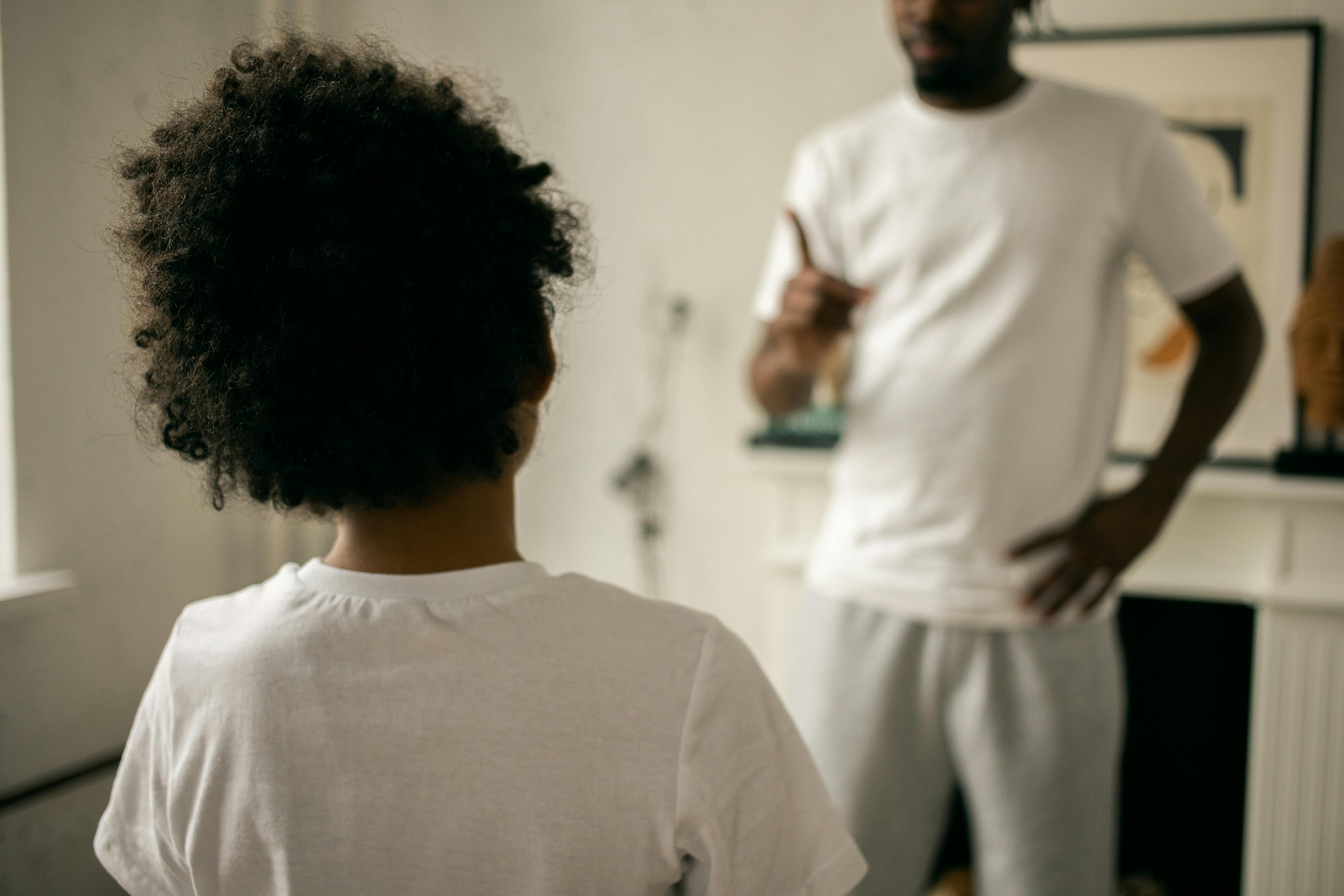 crop unrecognizable ethnic father scolding kid at home