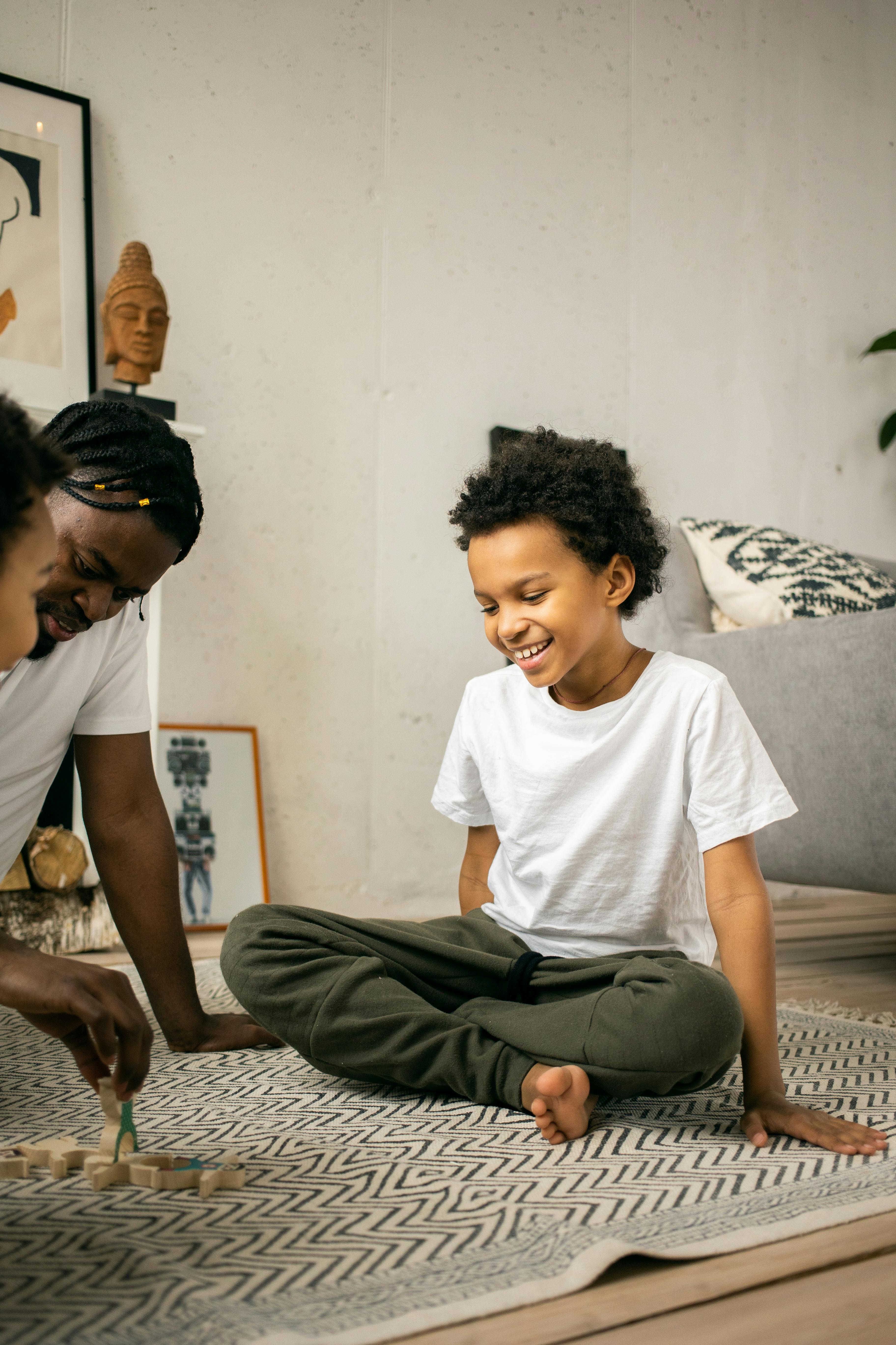 happy black father and kids playing while spending time together at home