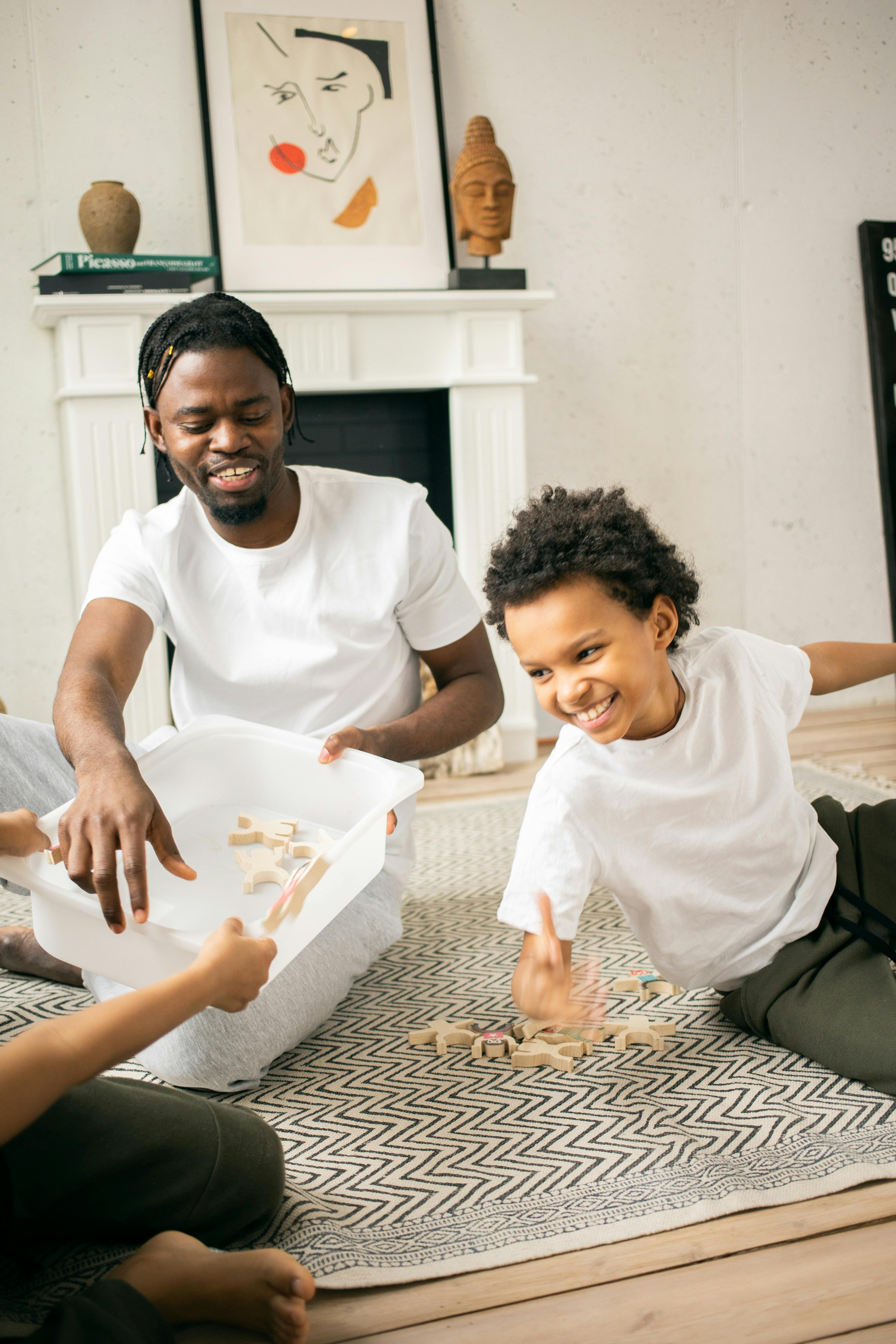 cheerful black father and son playing at home in daytime