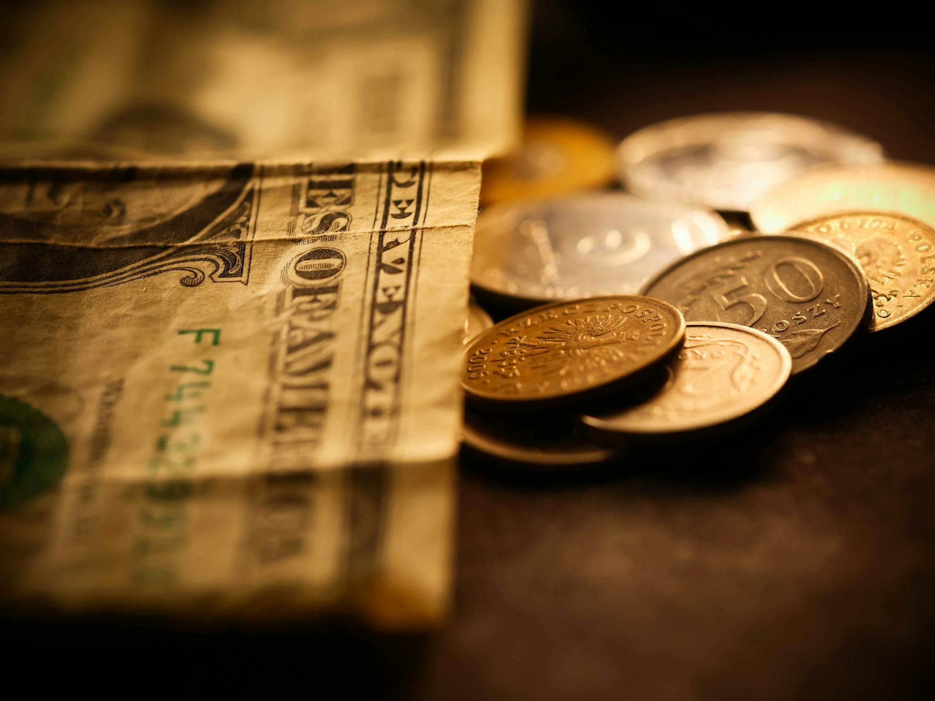 A close-up image of paper currency and coins, conveying a financial theme.