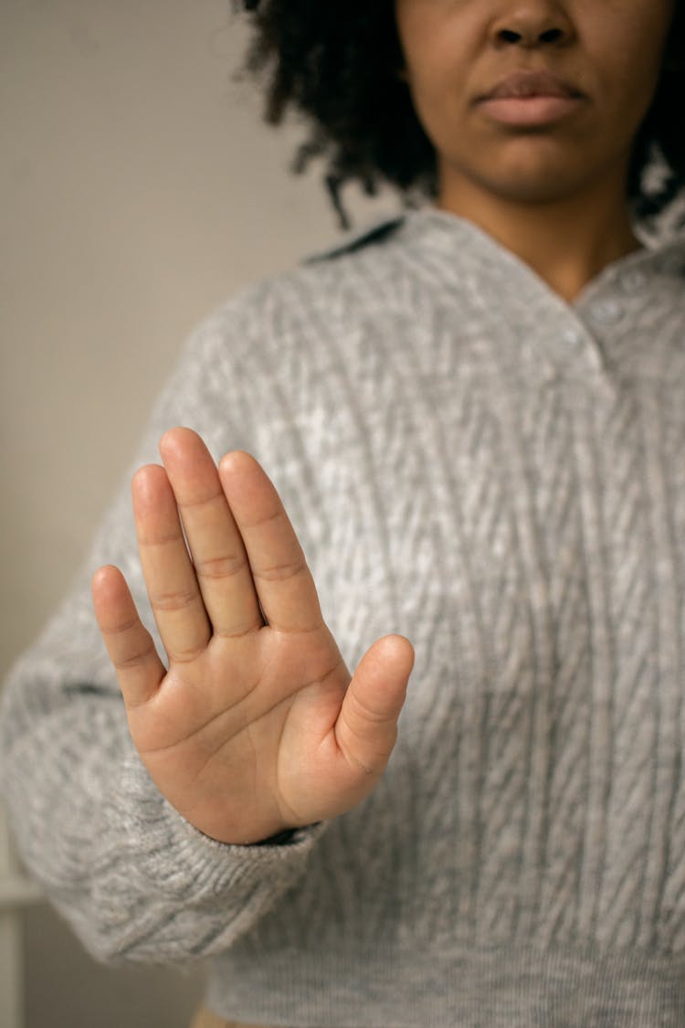 Black Woman Showing Palm In Light Room