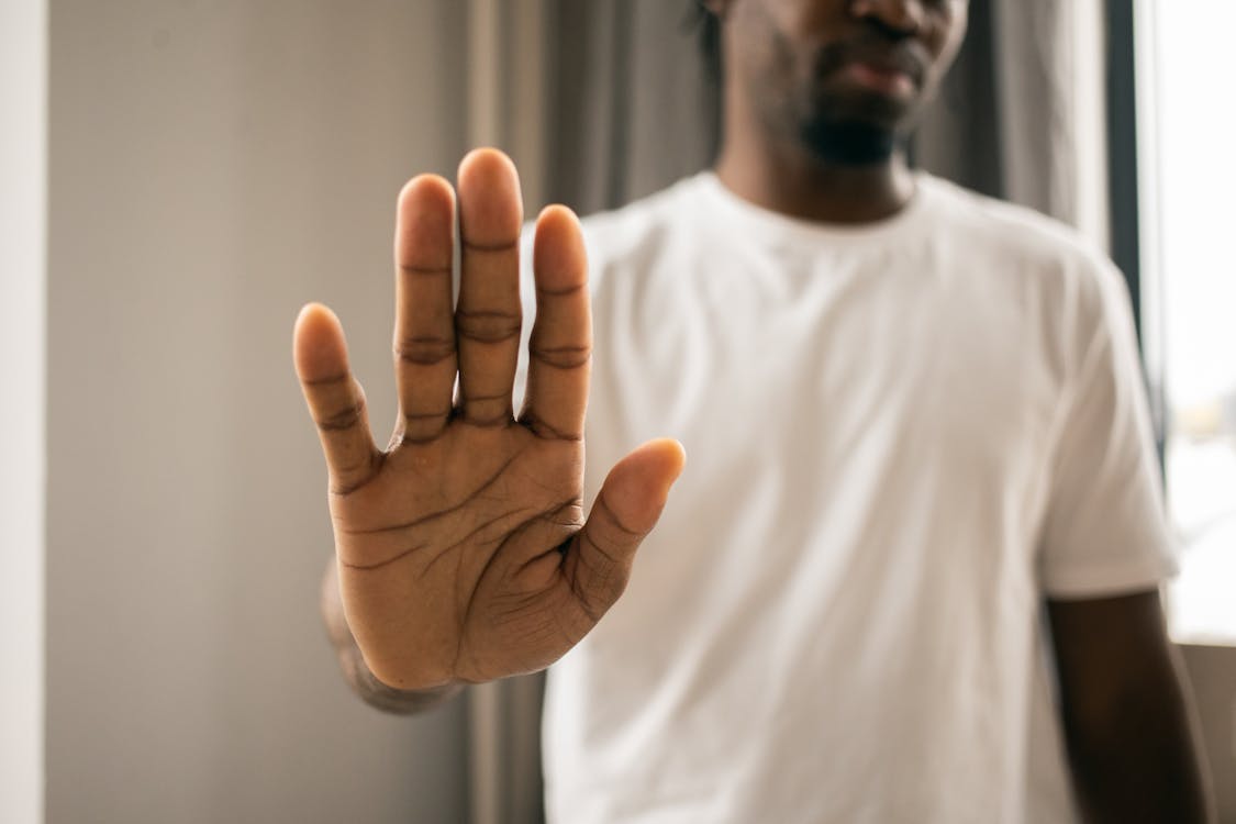 Free Unrecognizable black man showing stop gesture Stock Photo