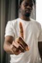 Black man with index finger pointing up