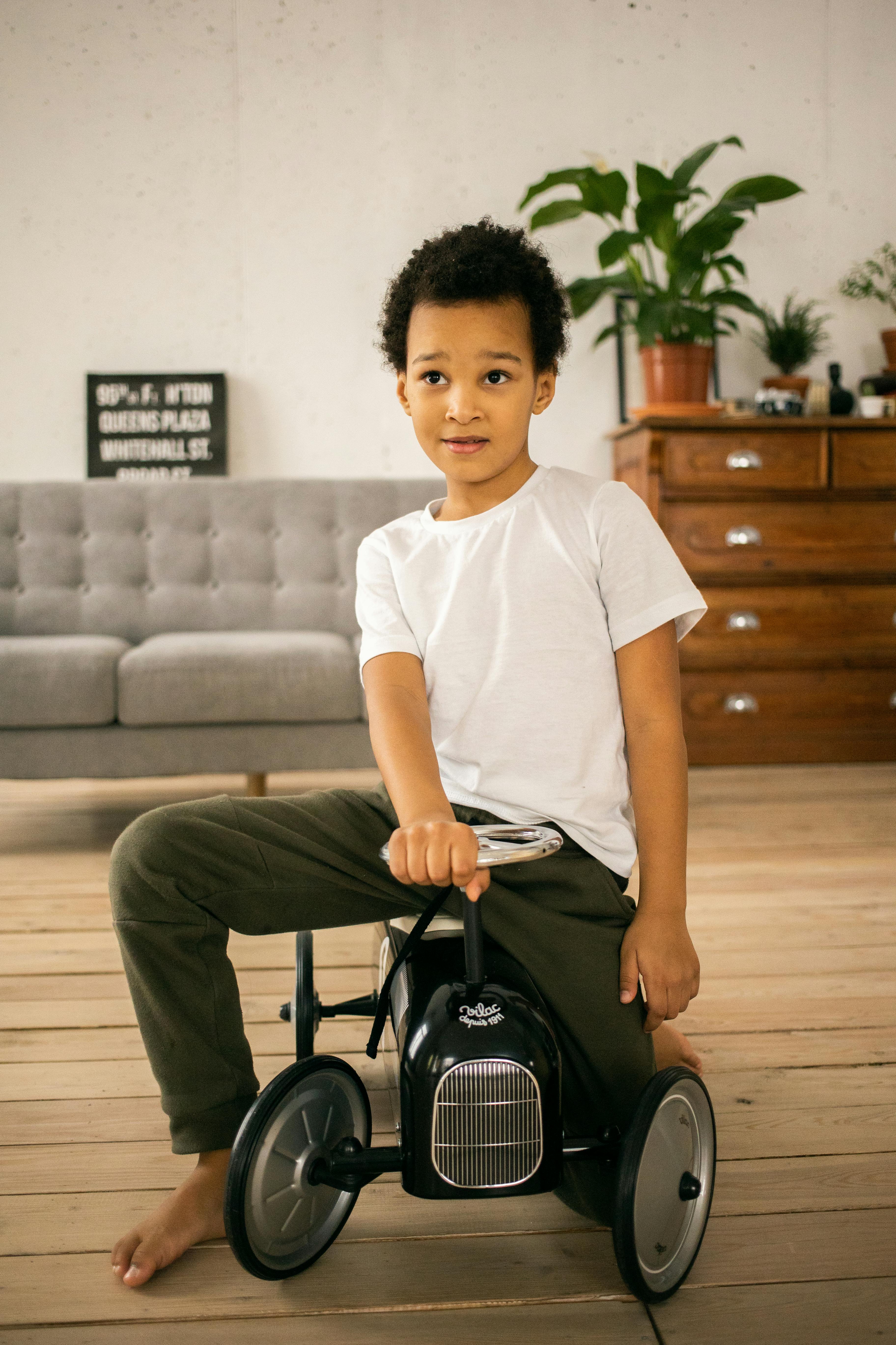 cute black boy on toy car