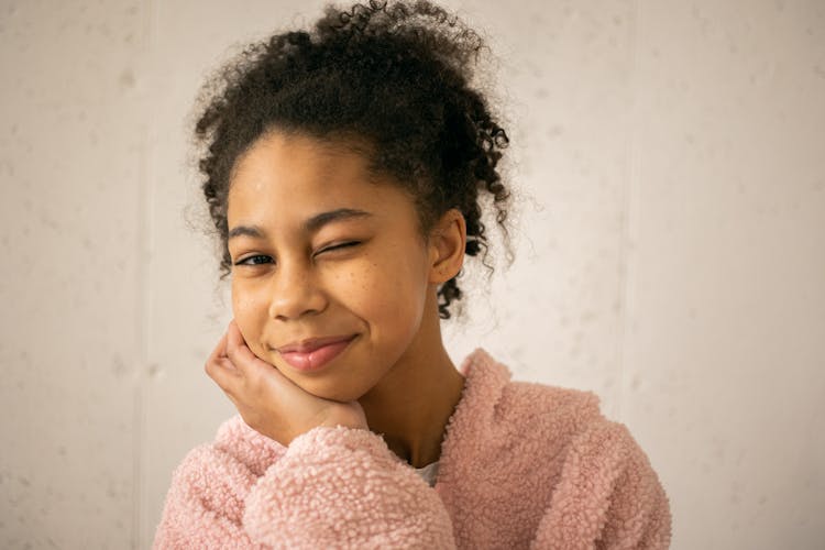 Cheerful Black Girl Winking At Camera