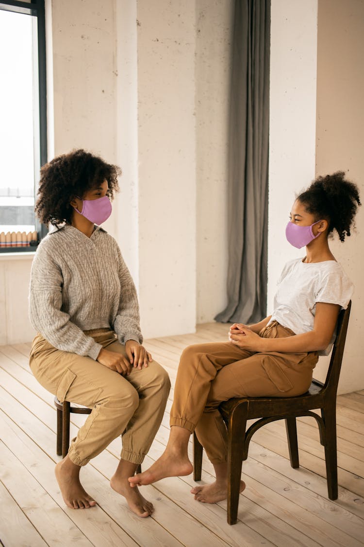 Black Mother With Daughter In Medical Masks