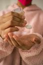 Anonymous woman applying antiseptic on hands