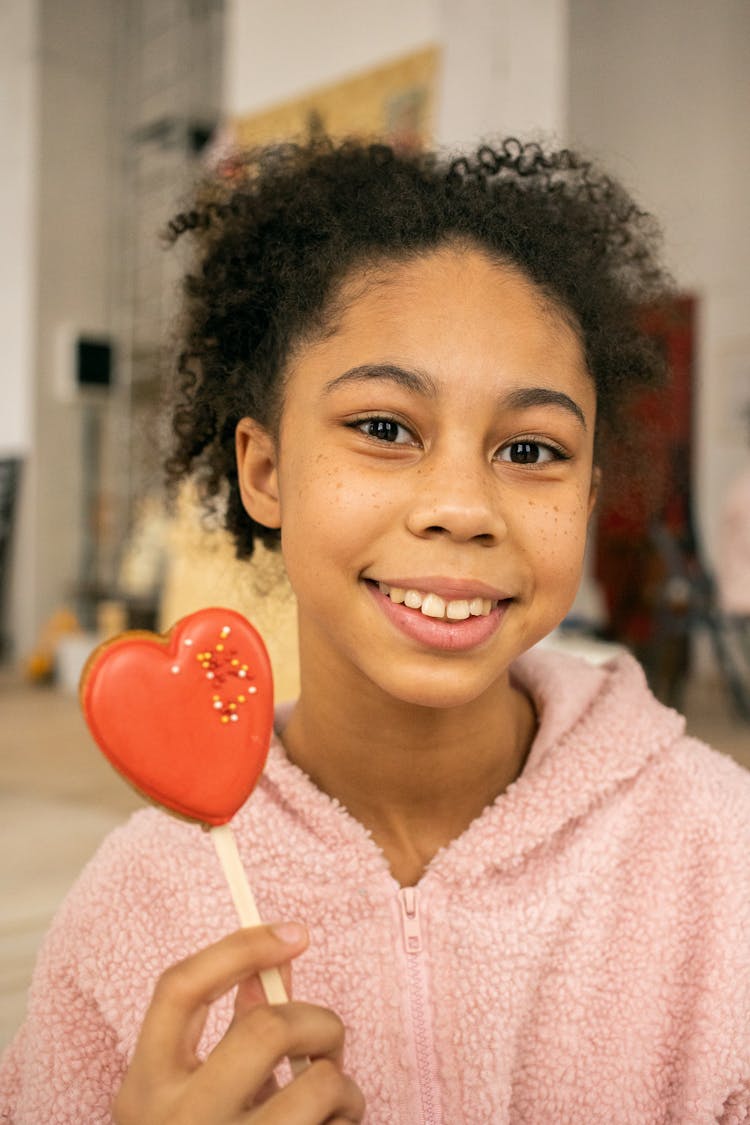 Cheerful Black Girl With Gingerbread Cookie