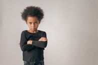Sad black girl near wall