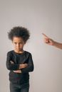 Unrecognizable person scolding black girl