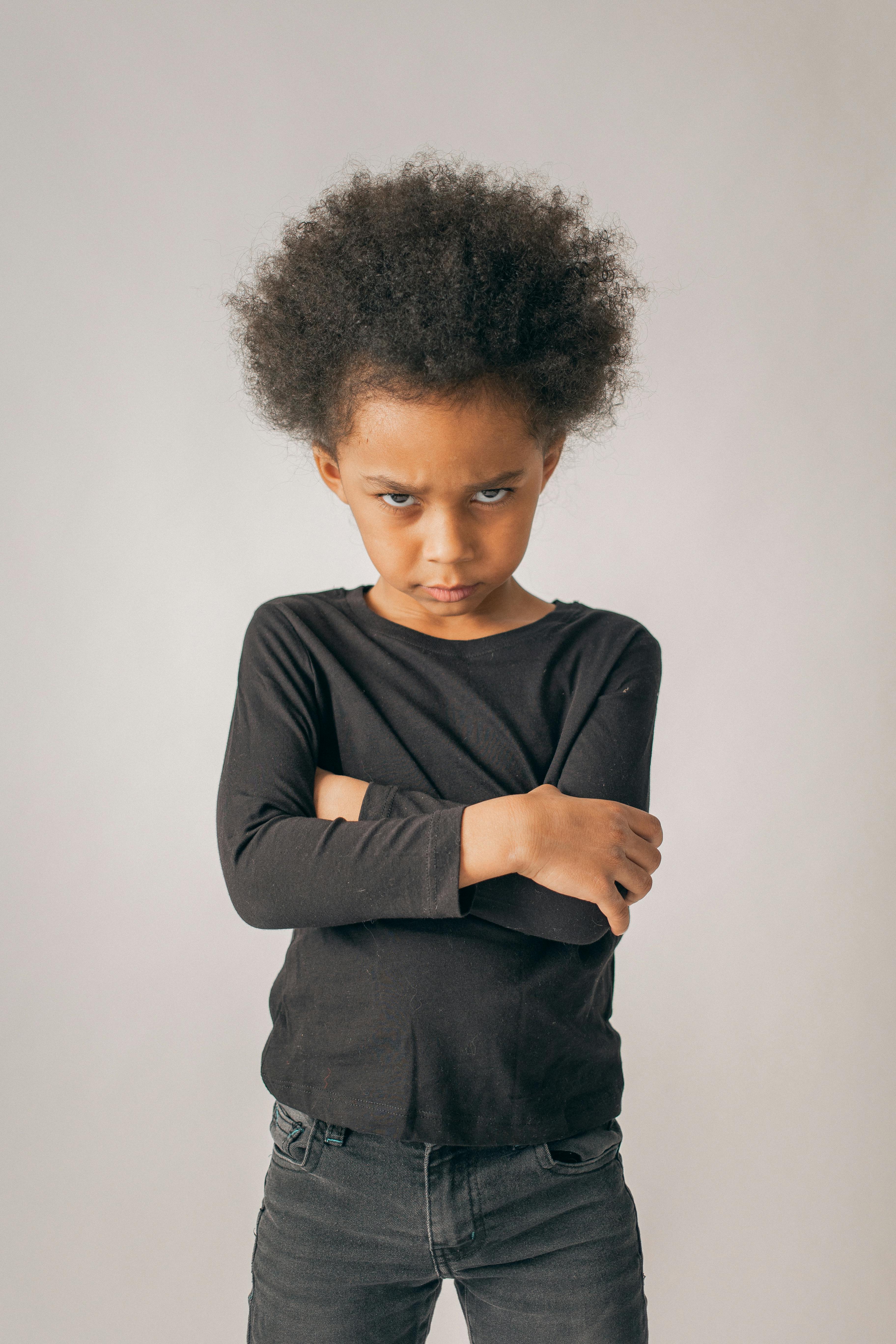 grumpy black girl near wall