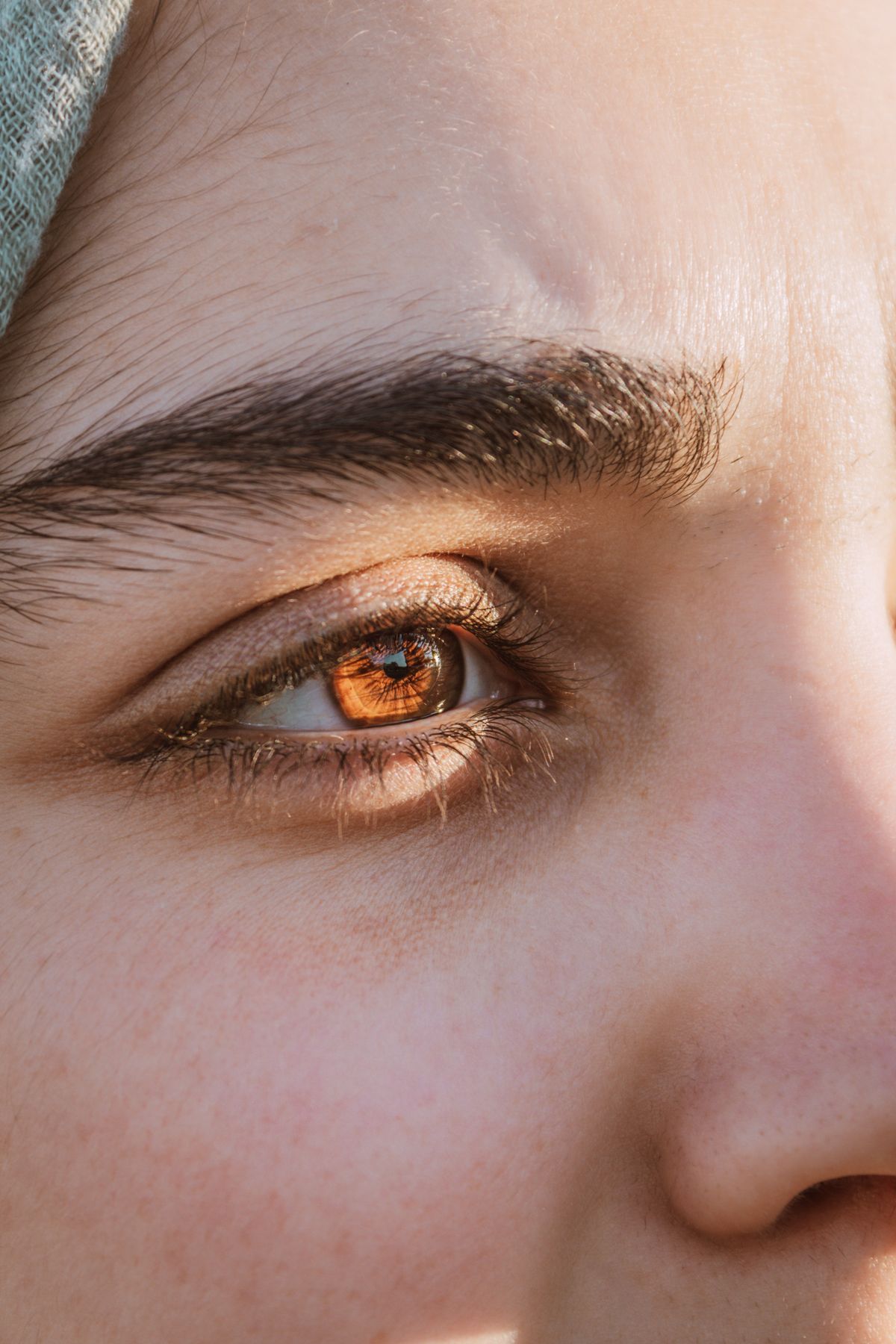 Close-up of the skin around a woman's eye showing fine lines and natural texture