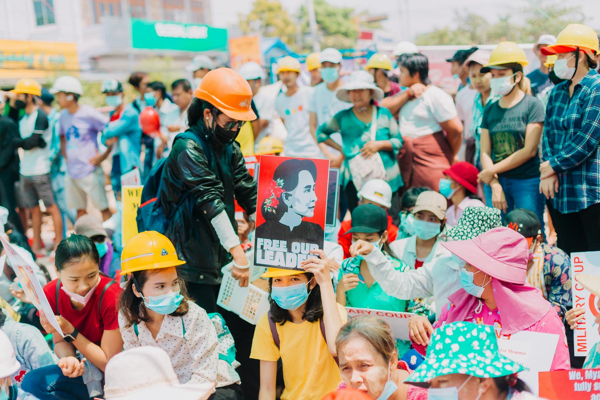 A large group of people in Yangon protests peacefully against the coup with signs and placards.