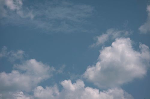 Free White fluffy cumulus clouds floating high in atmosphere on clear blue sky on sunny summer day in nature with sunshine Stock Photo