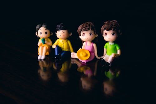 Free Small figurines on black surface Stock Photo